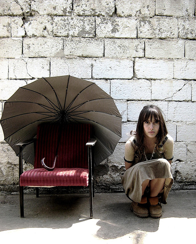 Blerta, umbrella & red foding chair, by Astrit Ismaili